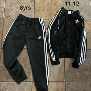 Adidas black track suit.